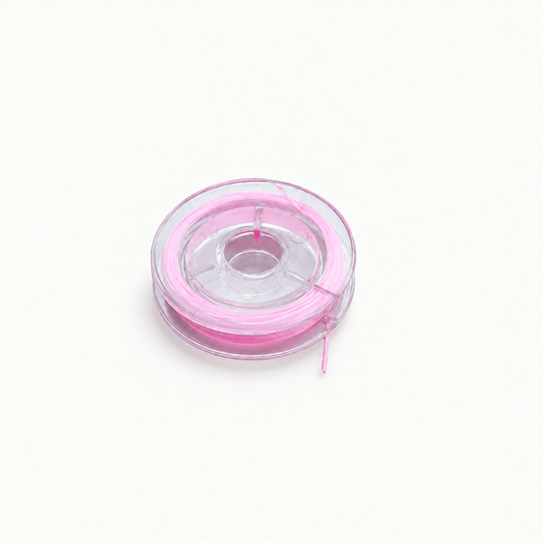 Roosa 0,8 mm elastikniidi pool ja niidi lähivaade