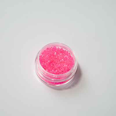 Miyuki Delica 11/0 koodiga DB-2035. Detailne lähivõte neoonsetest helendavatest maasikapunastest (Luminous Wild Strawberry) silindrilistest helmestest.